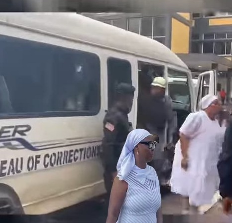 DRESSED IN WHITE, FACING THE STORM: BONDOO, HOWARD-TAYLOR CUT STRIKING FIGURES IN COURT DRESSED IN WHITE, FACING THE STORM: BONDOO, HOWARD-TAYLOR CUT STRIKING FIGURES IN COURT